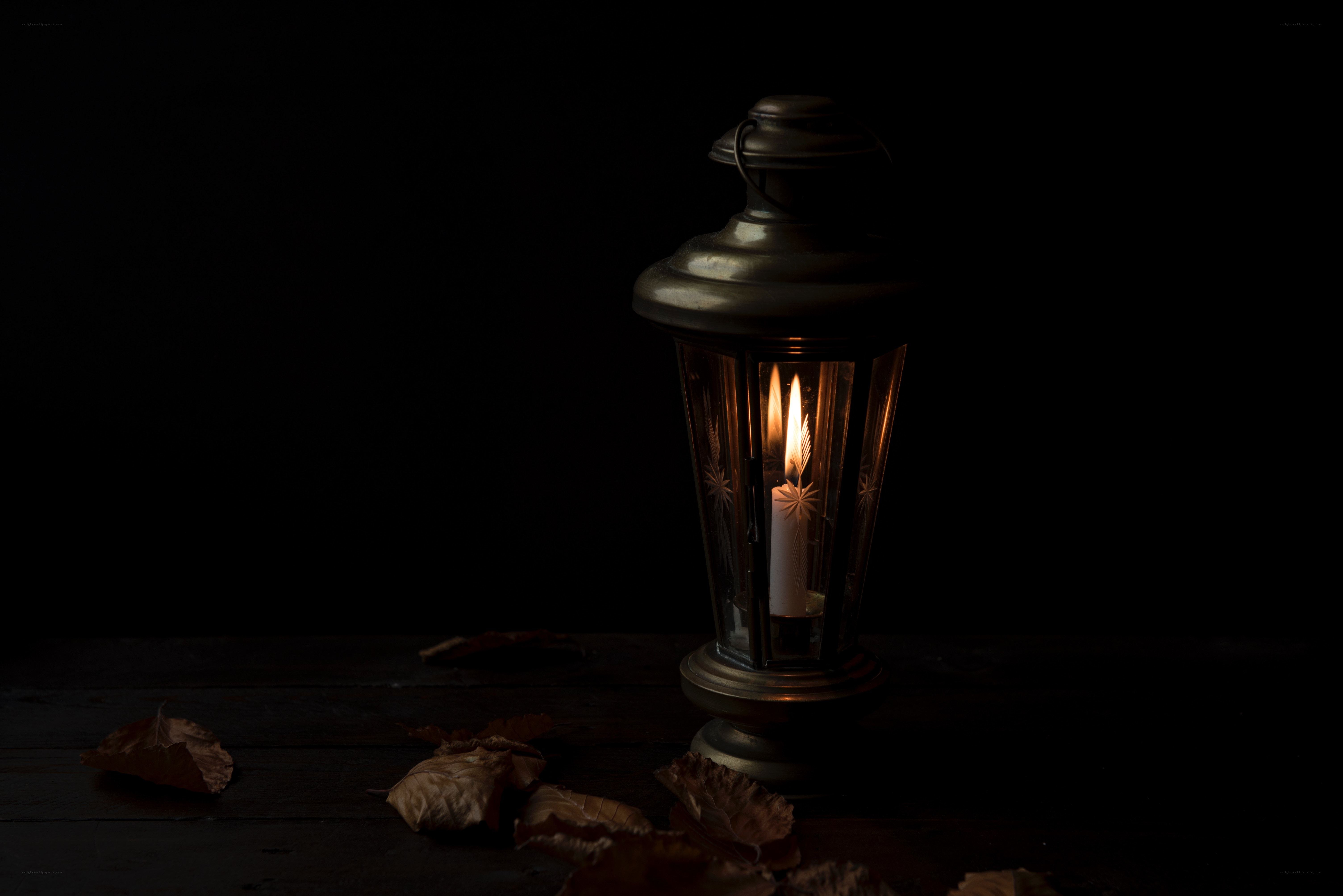 lit lantern with autumn leaves