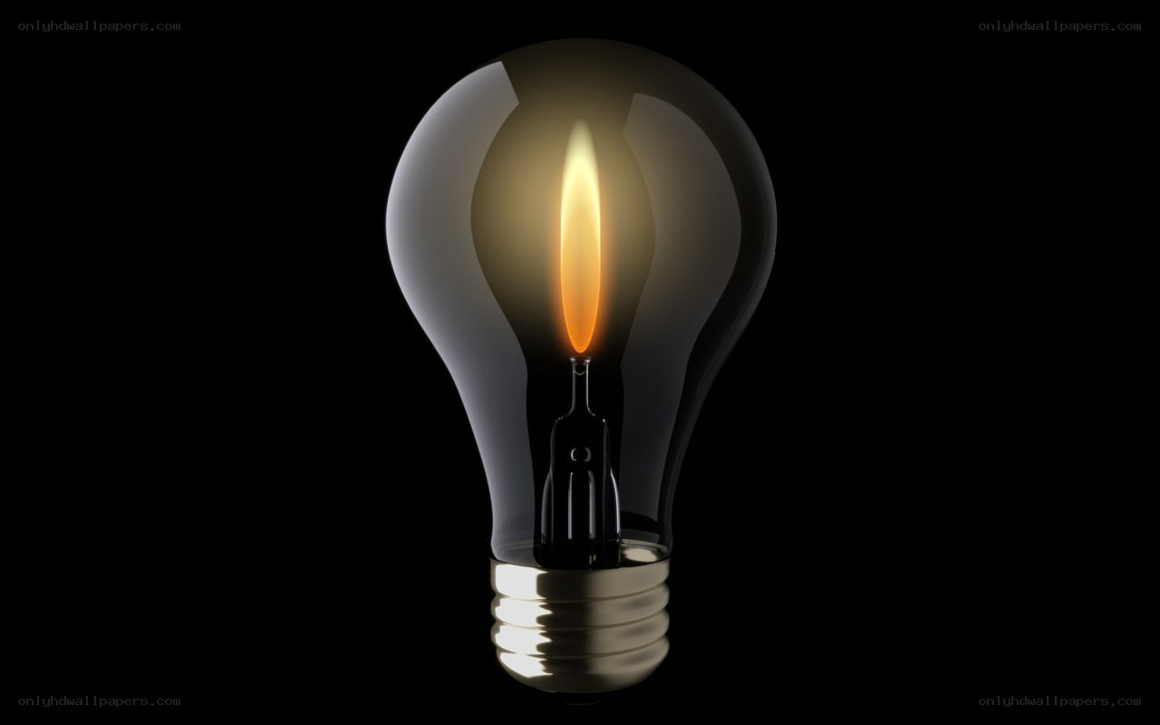 lit light bulb on black