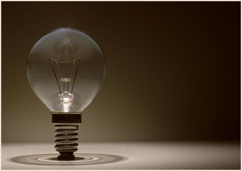 lit light bulb on dark background