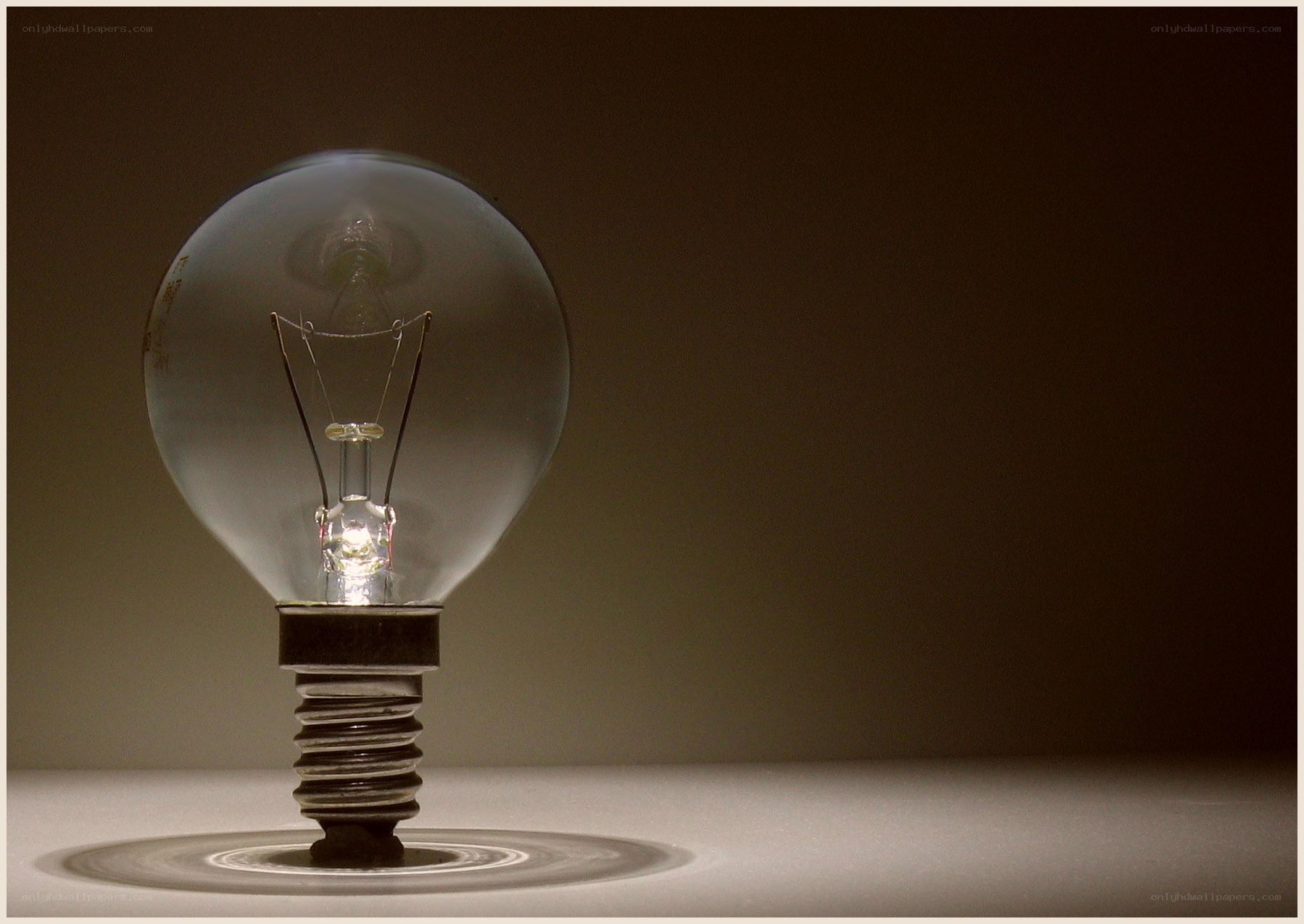 lit light bulb on dark background