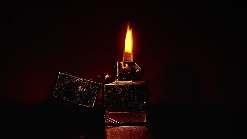 lit lighter in dark room