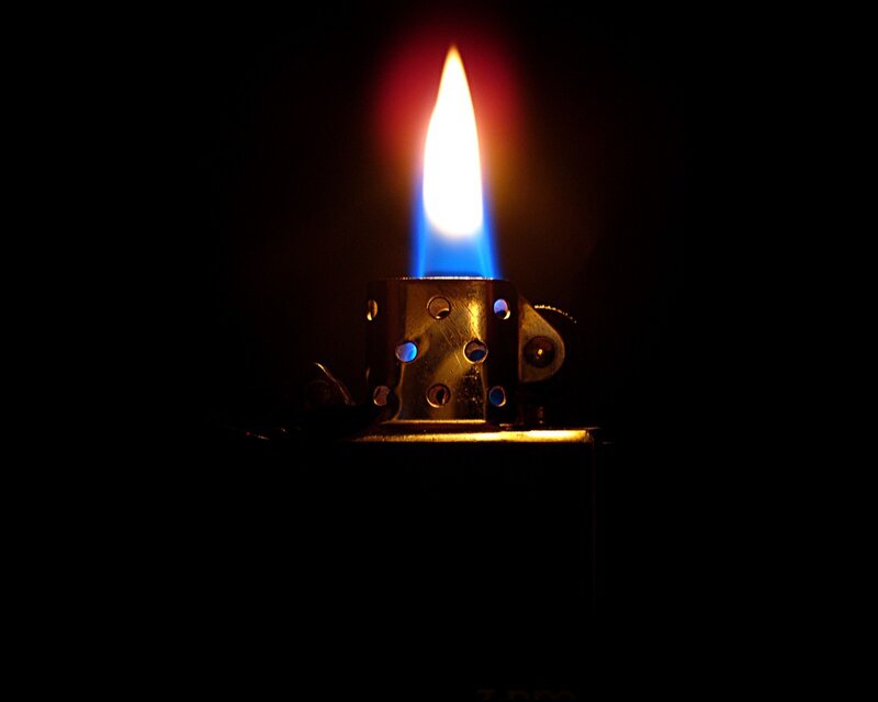 lit lighter in darkness