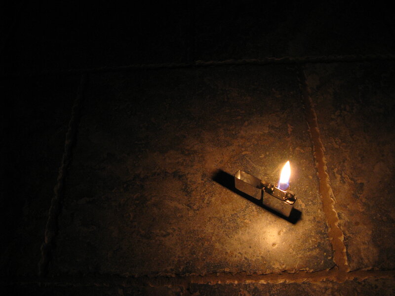 lit lighter on stone floor