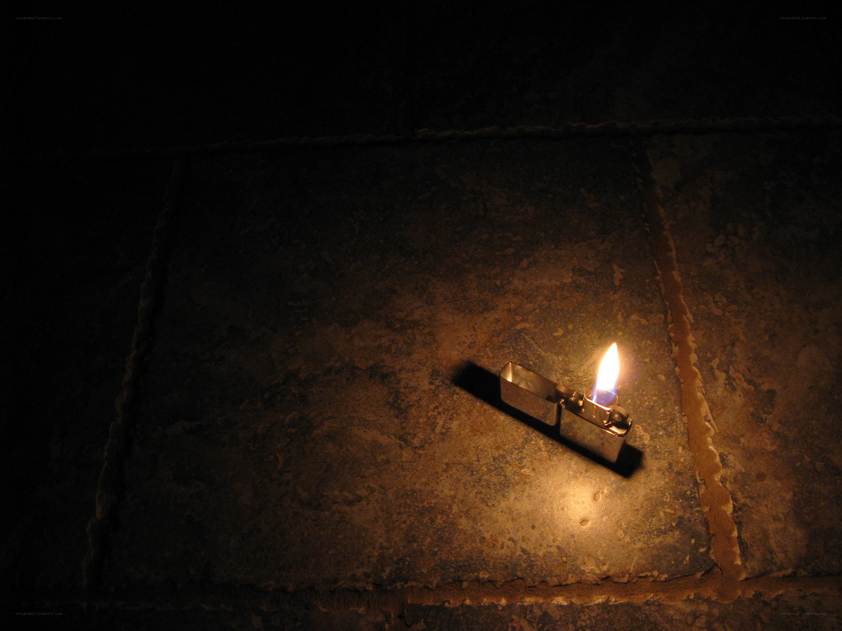 lit lighter on stone floor