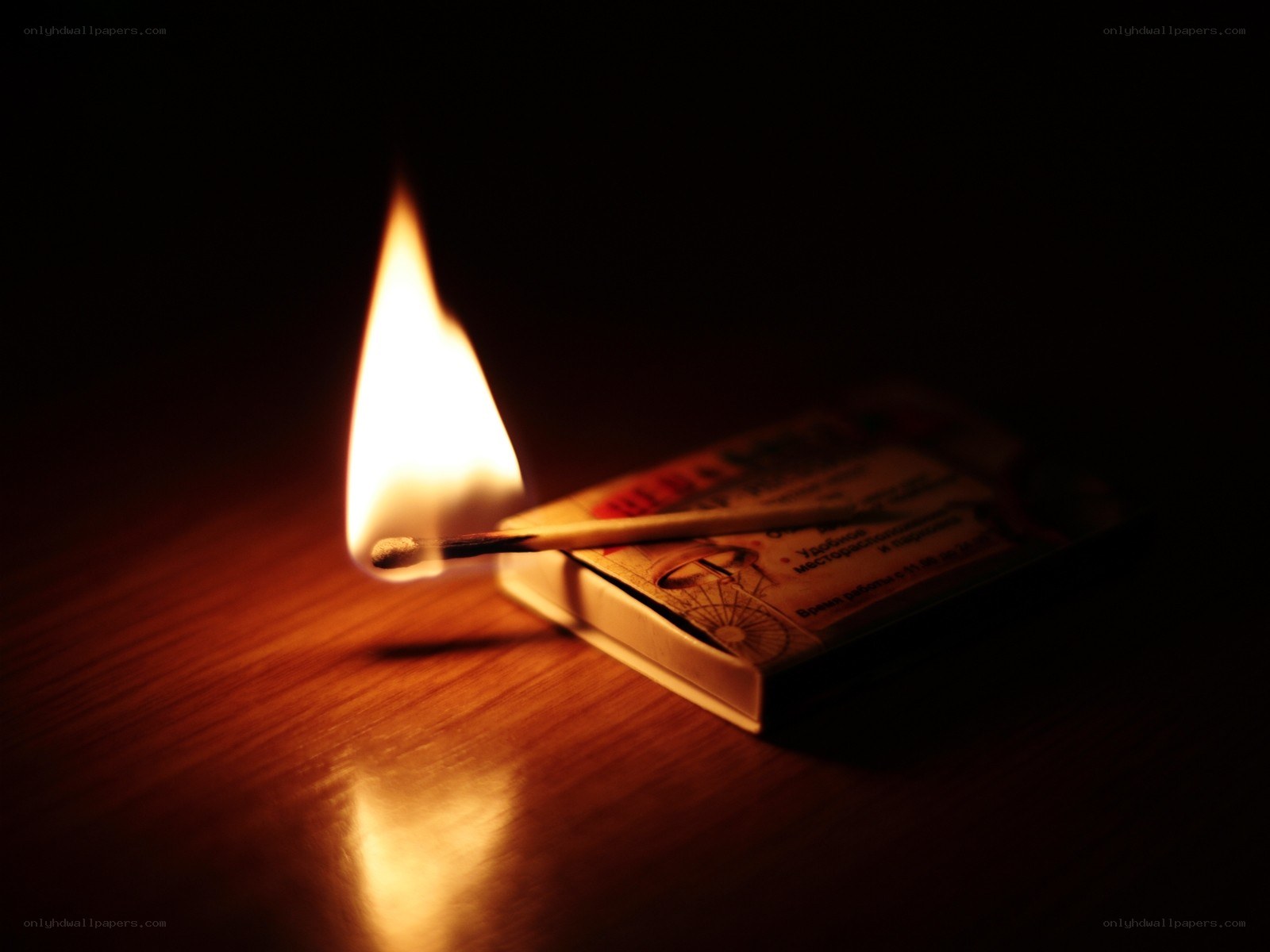 lit match on wooden surface
