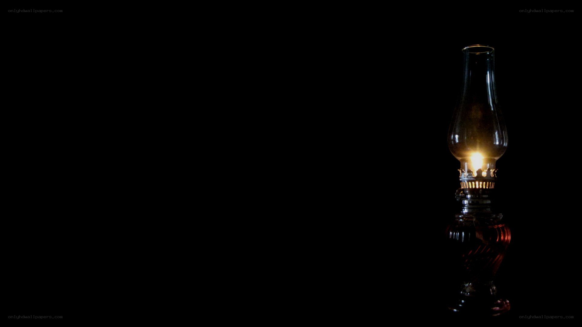 lit oil lamp in darkness