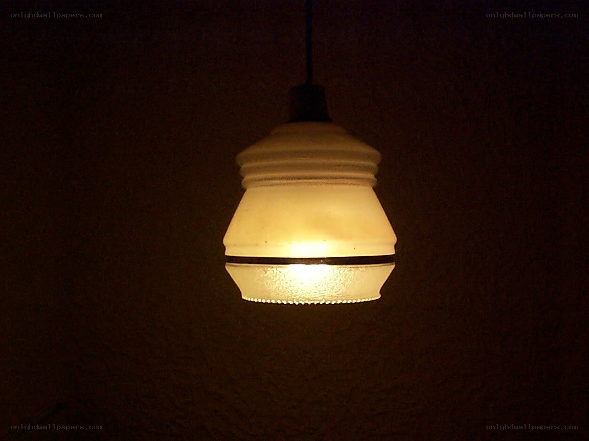 lit pendant lamp in dark room
