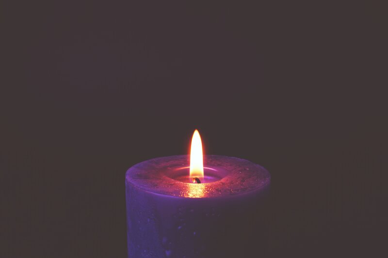 lit purple candle flame
