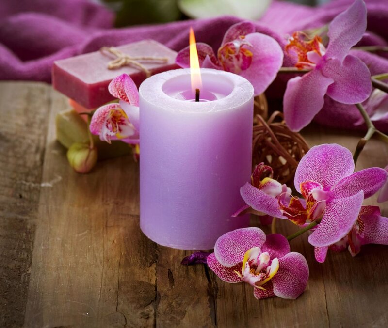 Lit Purple Candle with Orchids