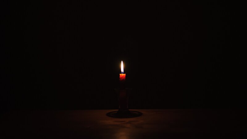 Lit Red Candle — Black