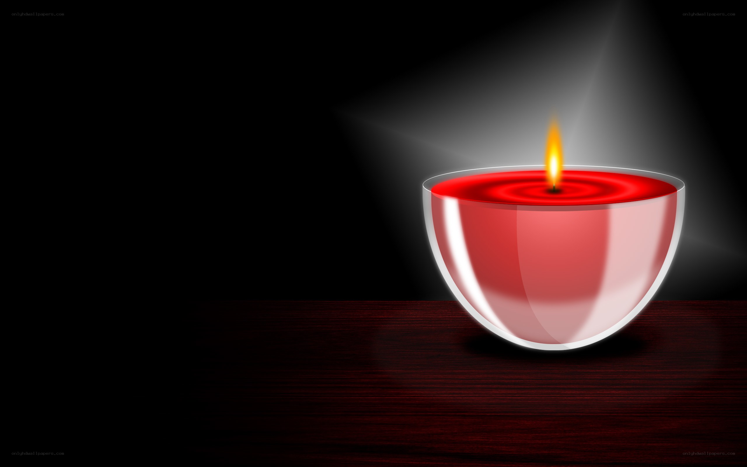 lit red candle on dark table