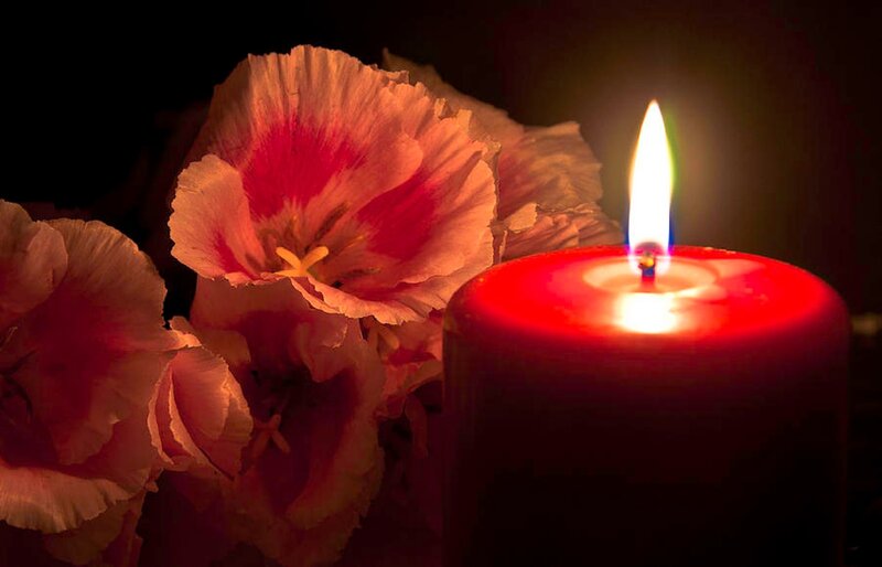 Lit Red Candle with Flowers