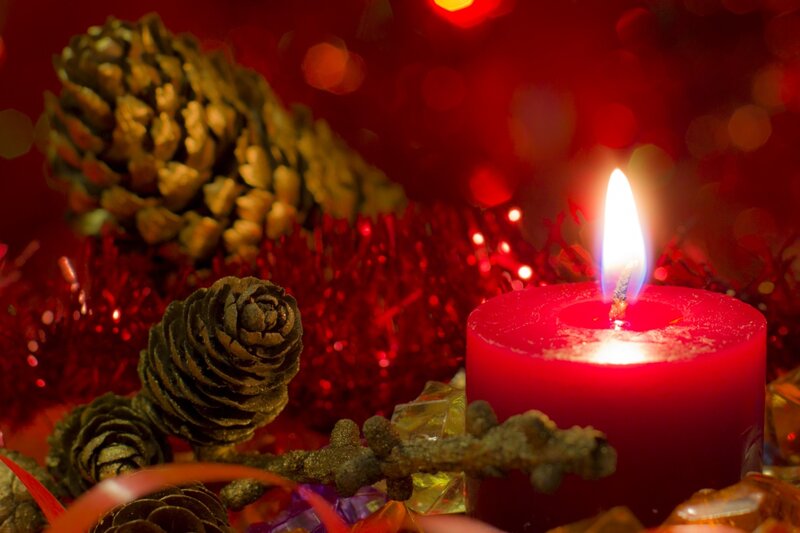 Lit Red Candle with Pinecones