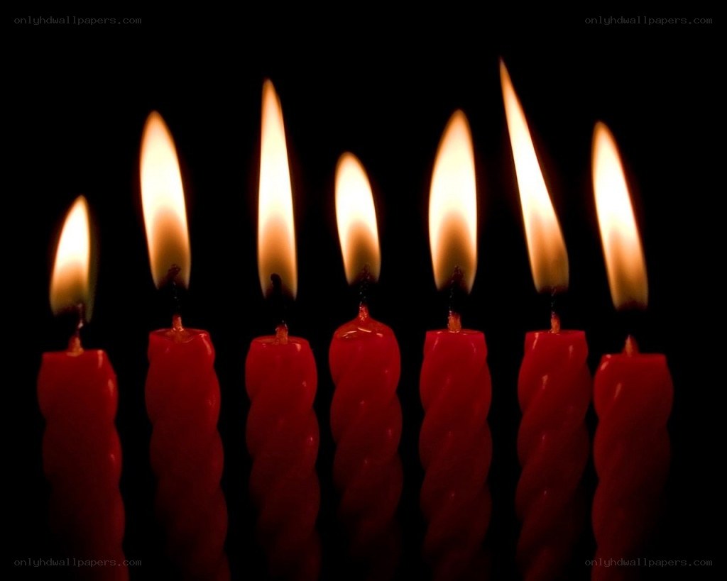 lit red candles in darkness