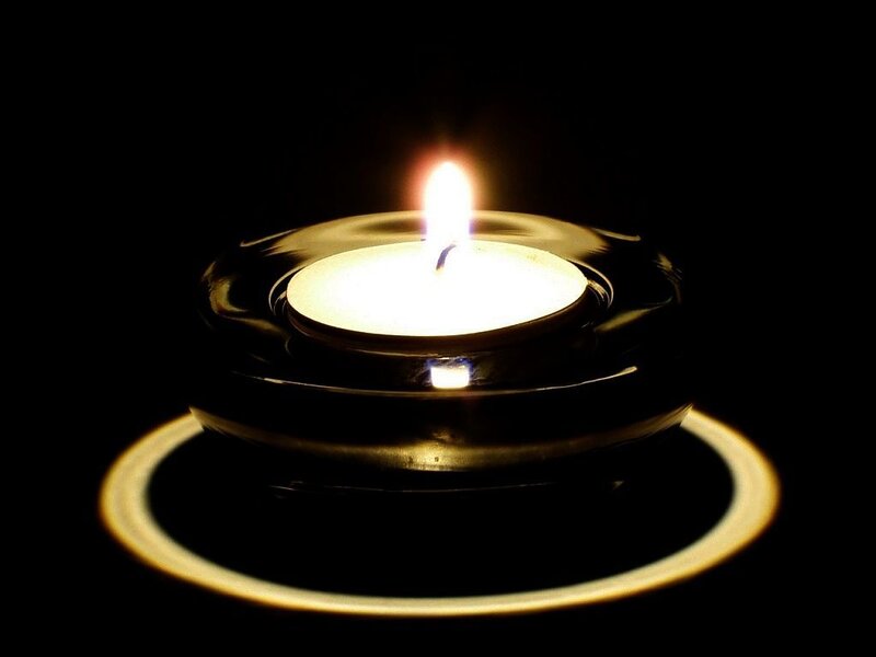 Lit Tea Light Candle — Black
