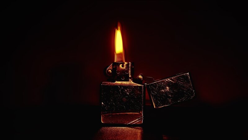 Lit Zippo Lighter — Black