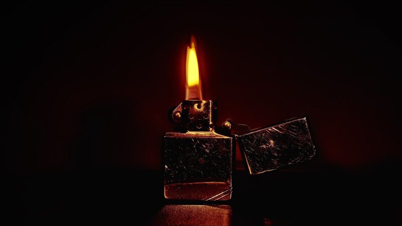 lit zippo lighter in dark