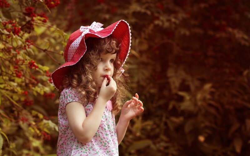 Little Girl Eating Berry