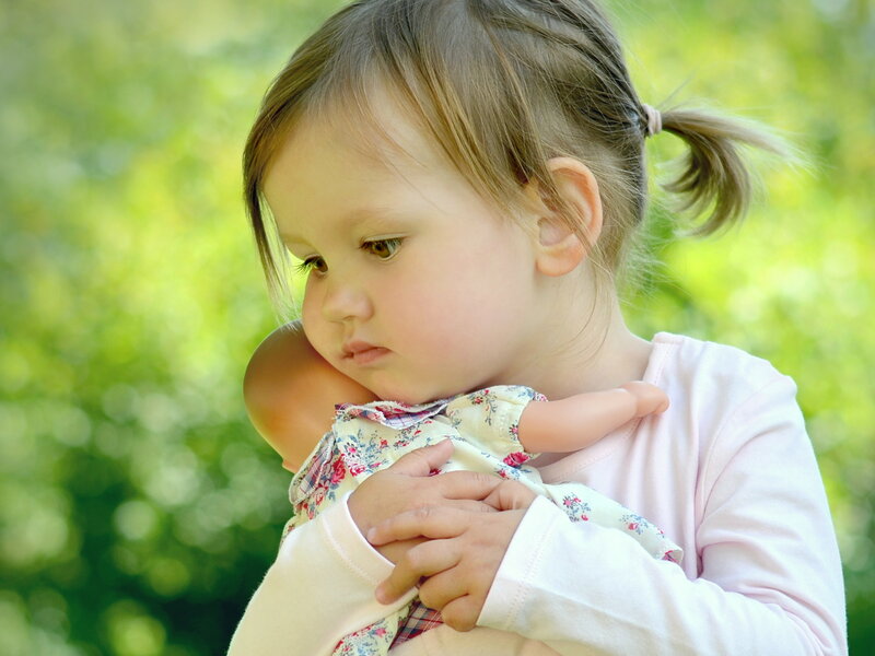 Little Girl Holding Doll