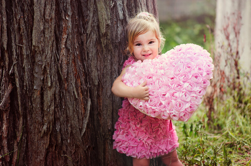Little Girl Holding Heart