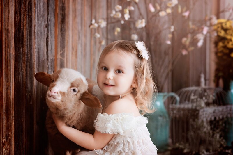 Little Girl Holding Lamb