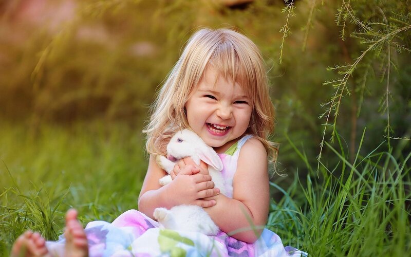 Little Girl Holding Rabbit — Green, Joyful