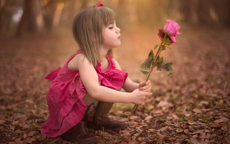 Little Girl Holding Rose