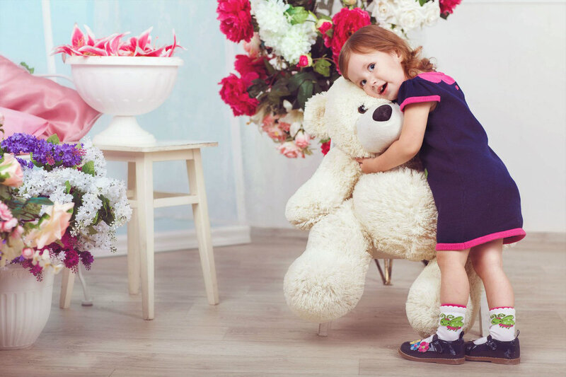 Little Girl Hugging Teddy Bear