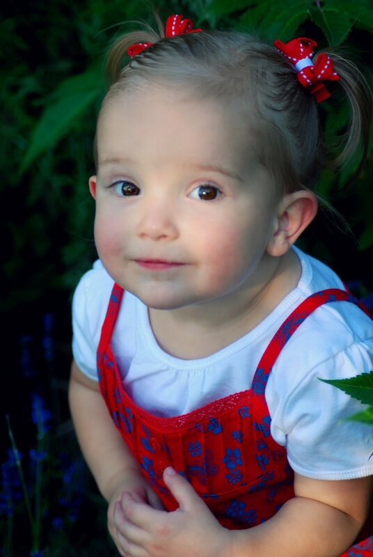 little girl in red overalls