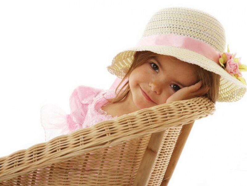 Little Girl in Wicker Chair