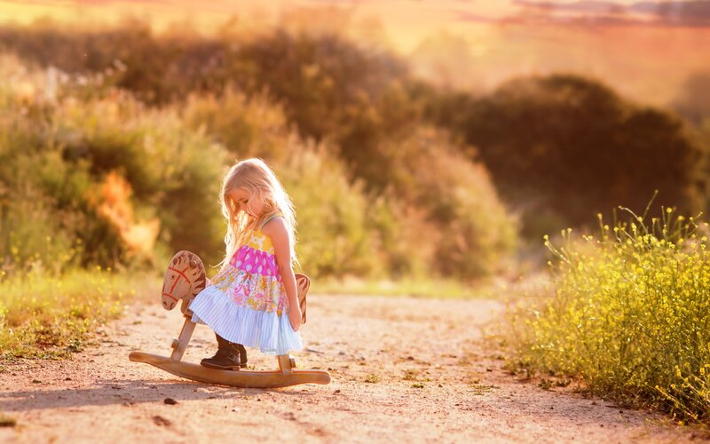Little Girl on Rocking Horse — Golden