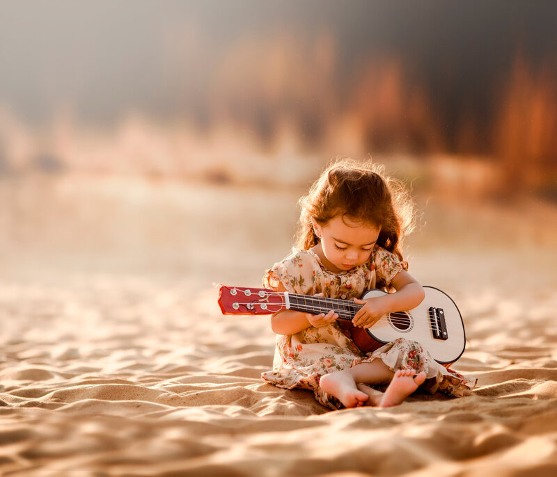 Little Girl Playing Ukulele