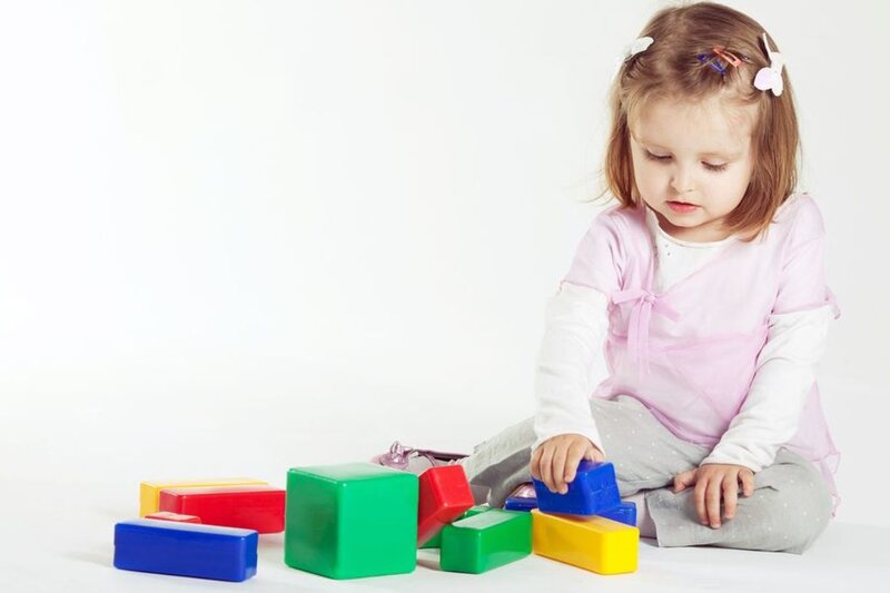 Little Girl Playing with Blocks
