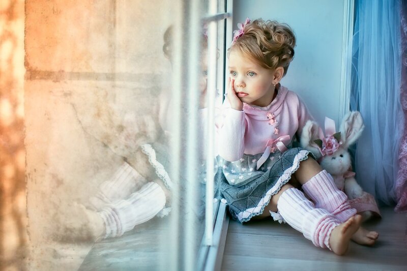 Little Girl Sitting by Window