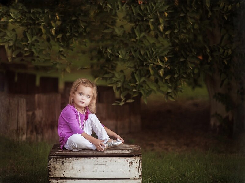 Little Girl Sitting on Crate