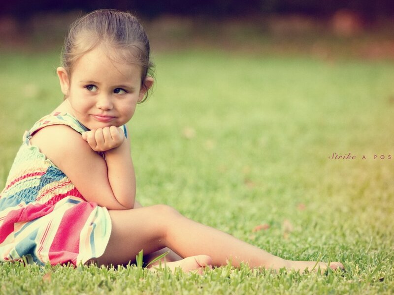 Little Girl Sitting on Grass