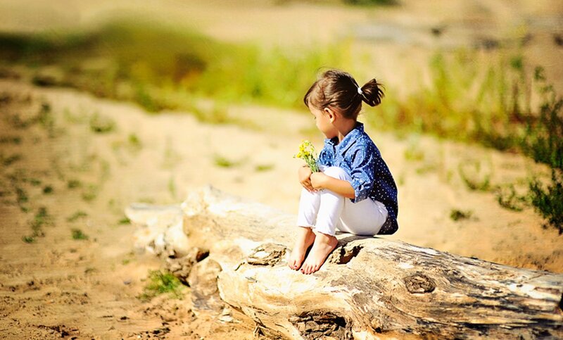 Little Girl Sitting on Log