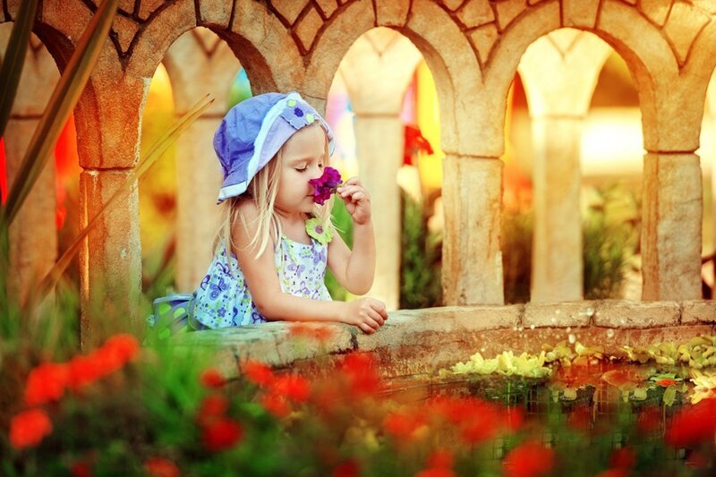 Little Girl Smelling Flower