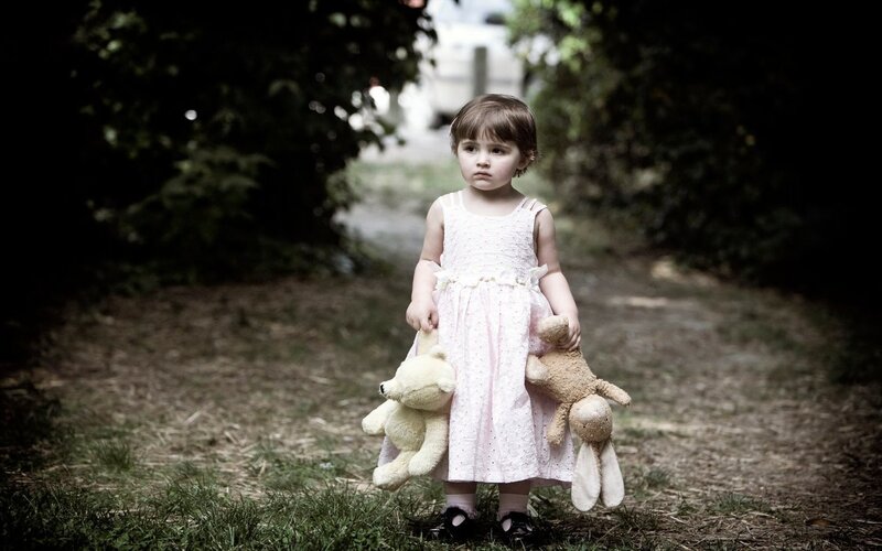Little girl with stuffed animals