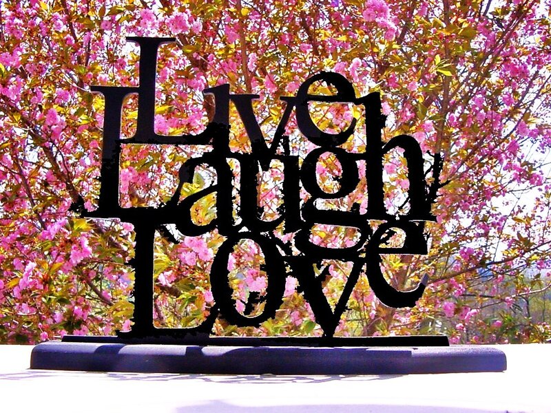 Live Laugh Love sign with cherry blossoms