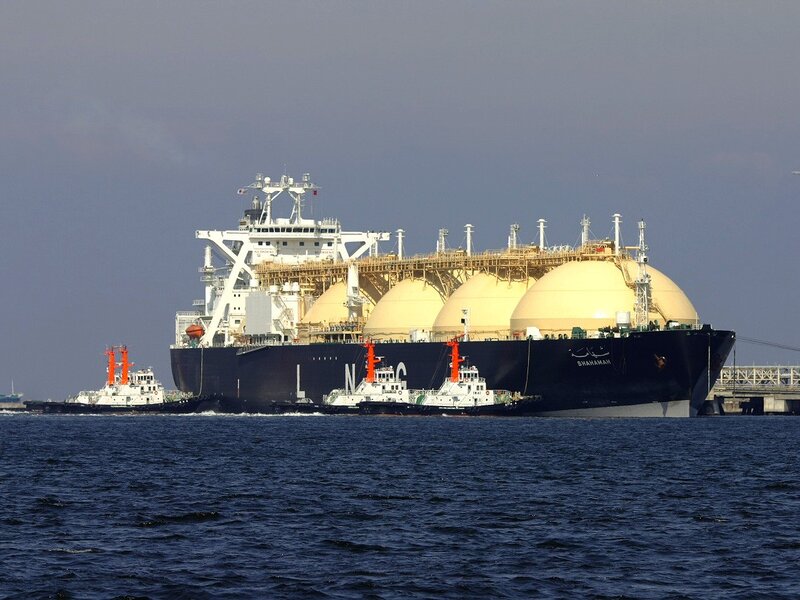 LNG tanker with tugboats