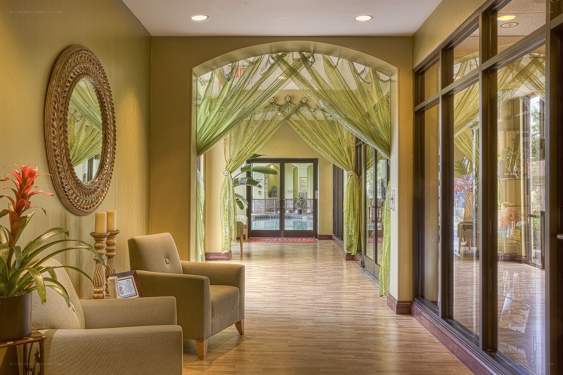 Lobby with green drapes and pool view