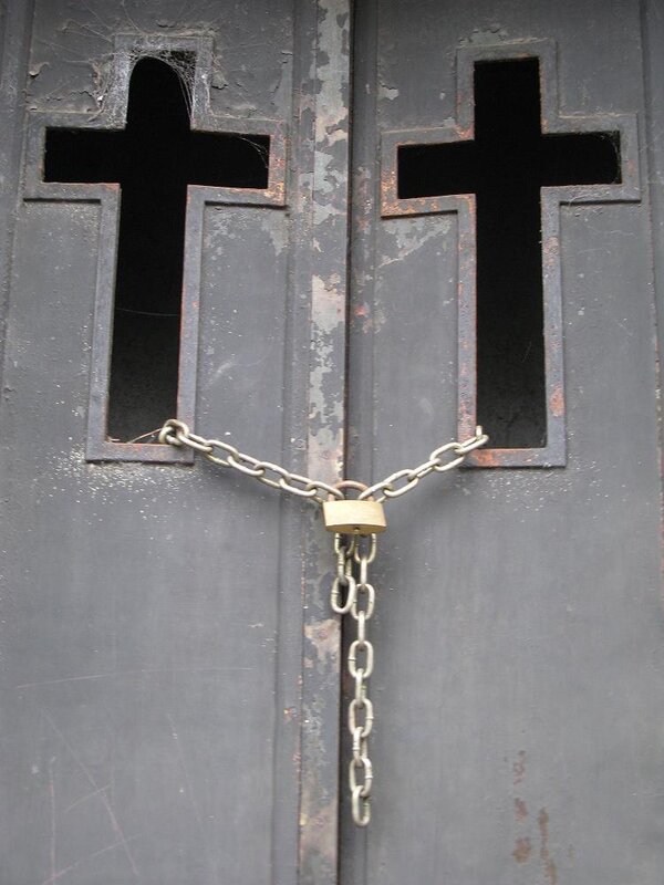 Locked church doors with crosses