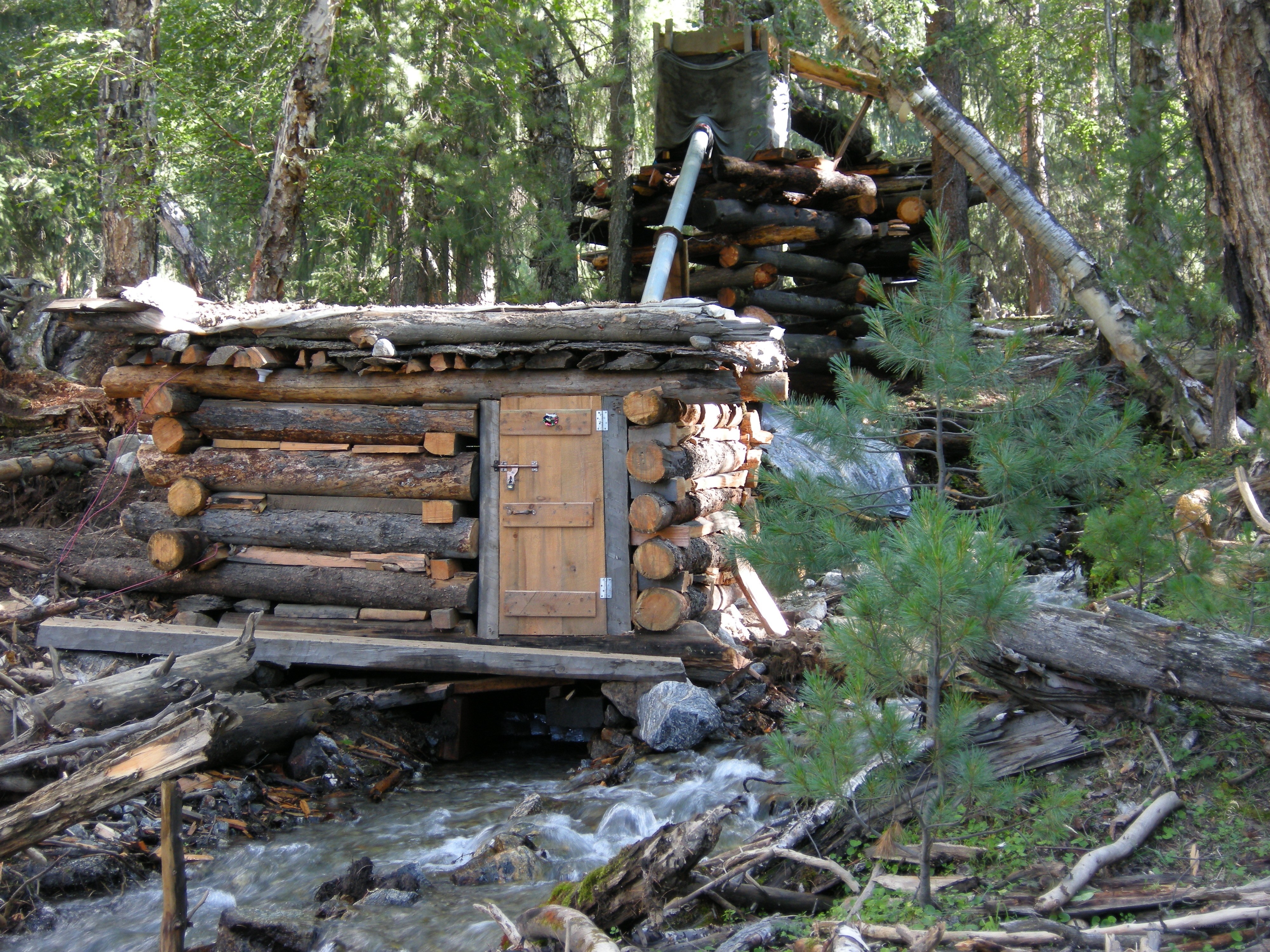 Log cabin by a stream