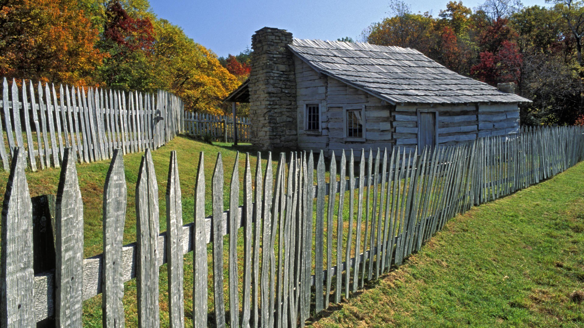 Log cabin in autumn landscape