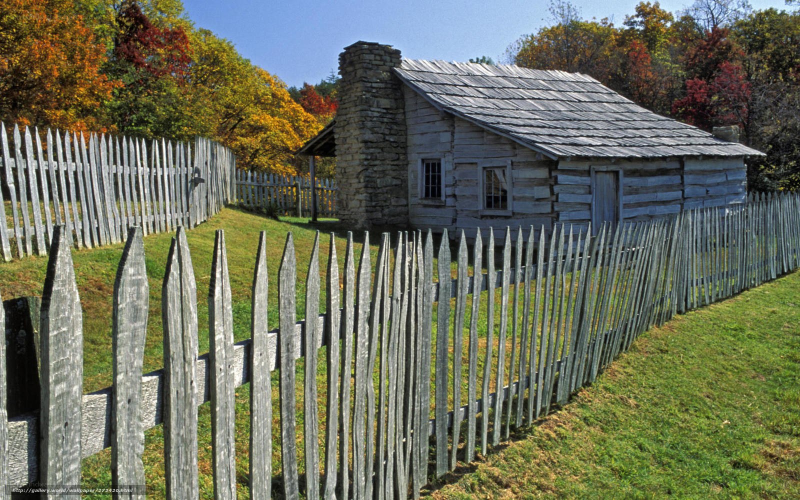 log cabin in autumn landscape
