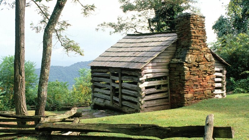 log cabin in mountain landscape