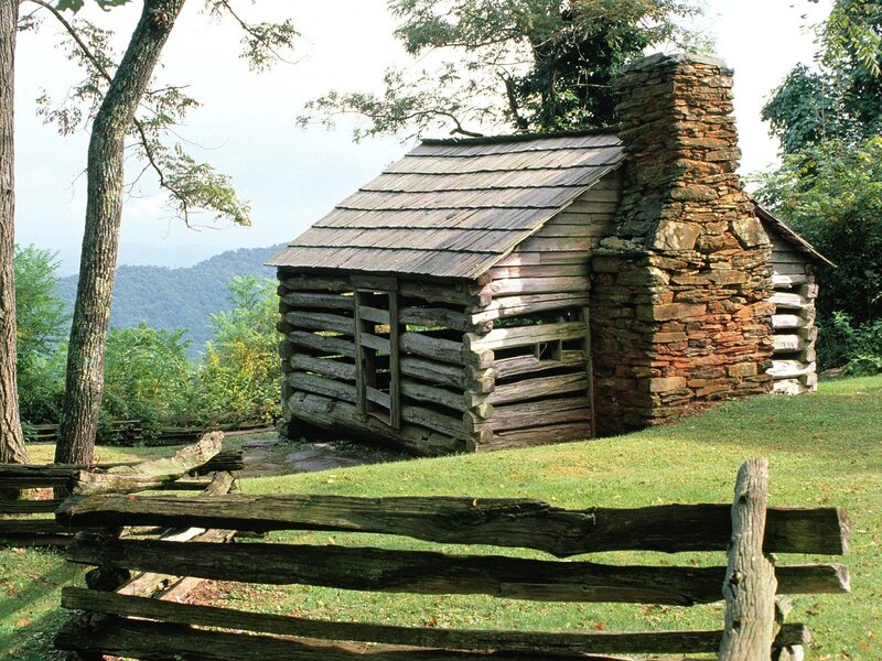 Log cabin in mountain landscape