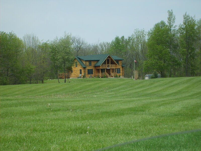Log cabin on a grassy hill