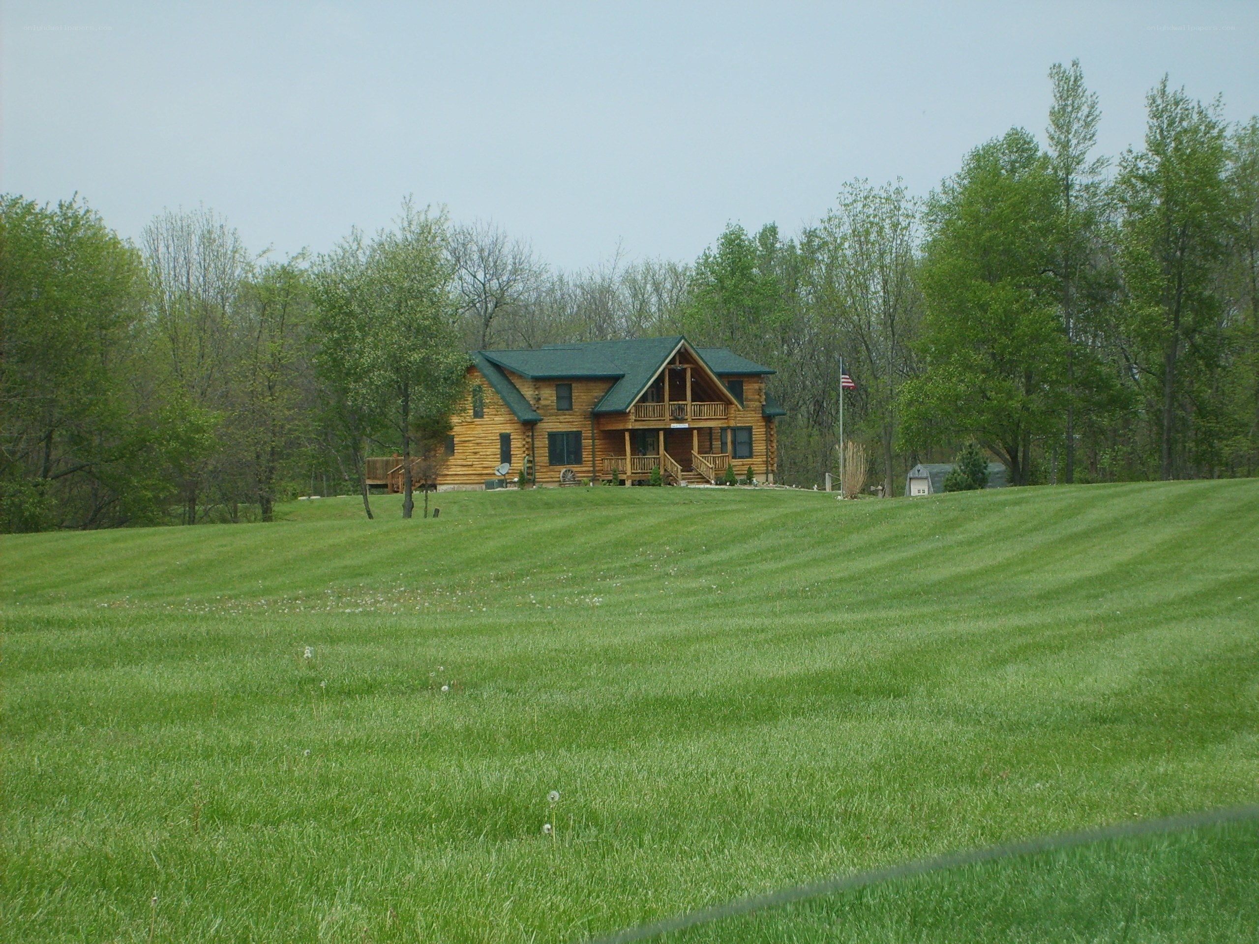 Log cabin on a grassy hill